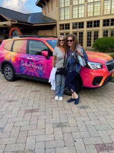 Lori and Gayle leaning on Bethelwoods colorful van
