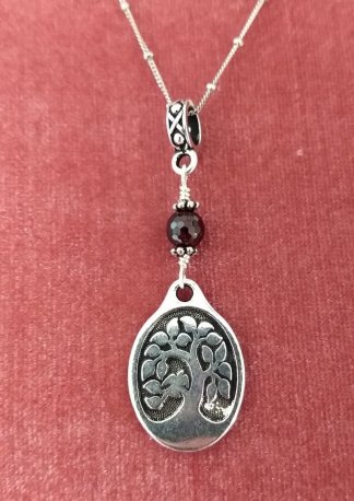 oval tree of Life with faceted Garnet accent