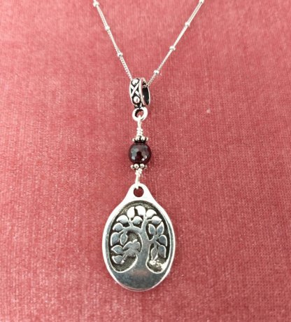 oval tree of Life with faceted Garnet accent