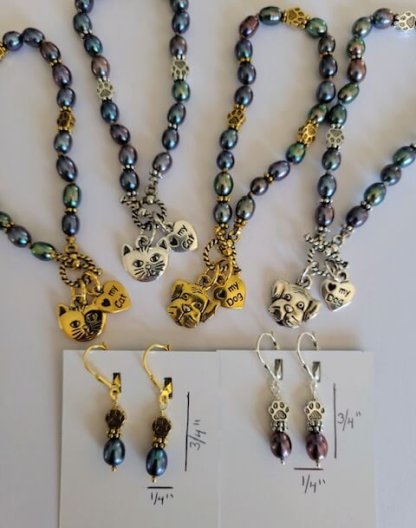 Collection of Pets and Paws bracelets and earrings in silver and gold.